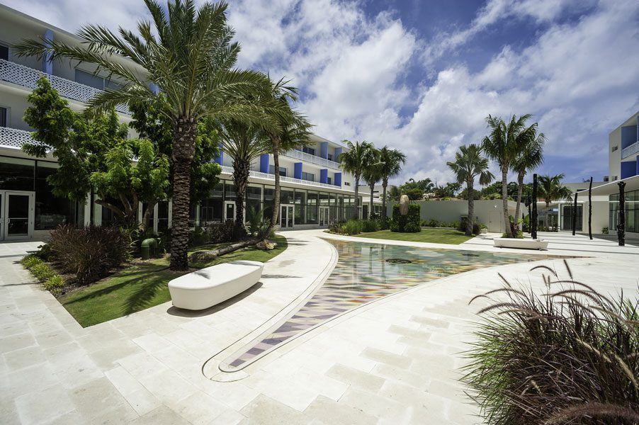 Contemporary building with lush garden and pool