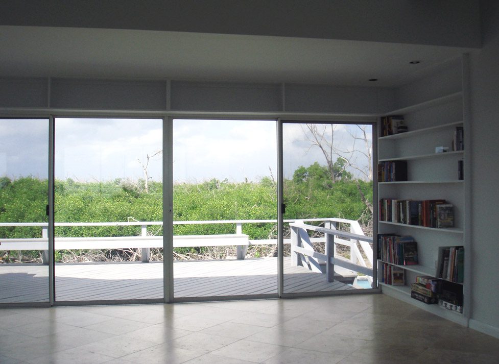Room overlooking lush greenery and deck