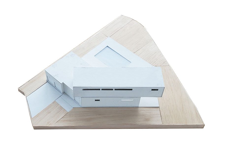 Minimalist building model on wooden base